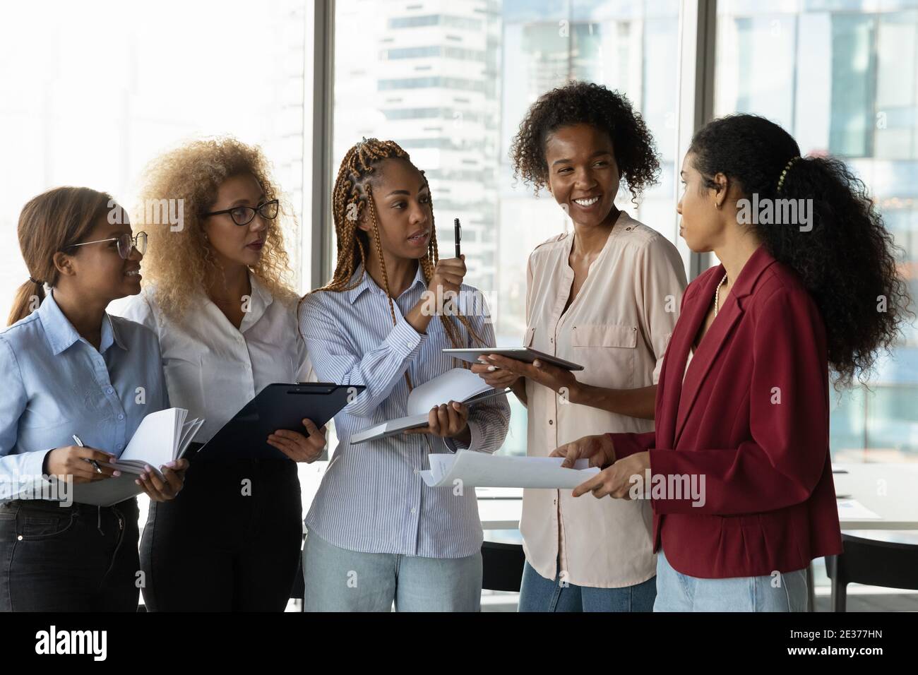 Multiracial female colleagues brainstorm together in office Stock Photo ...