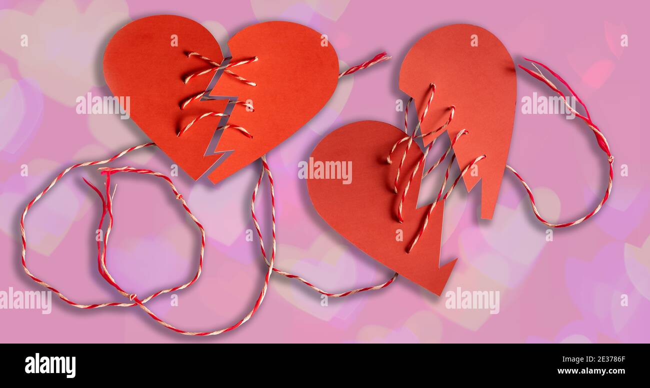 Valentines day concept,Paper cutting technique,A broken heart pulled by a rope. Stock Photo