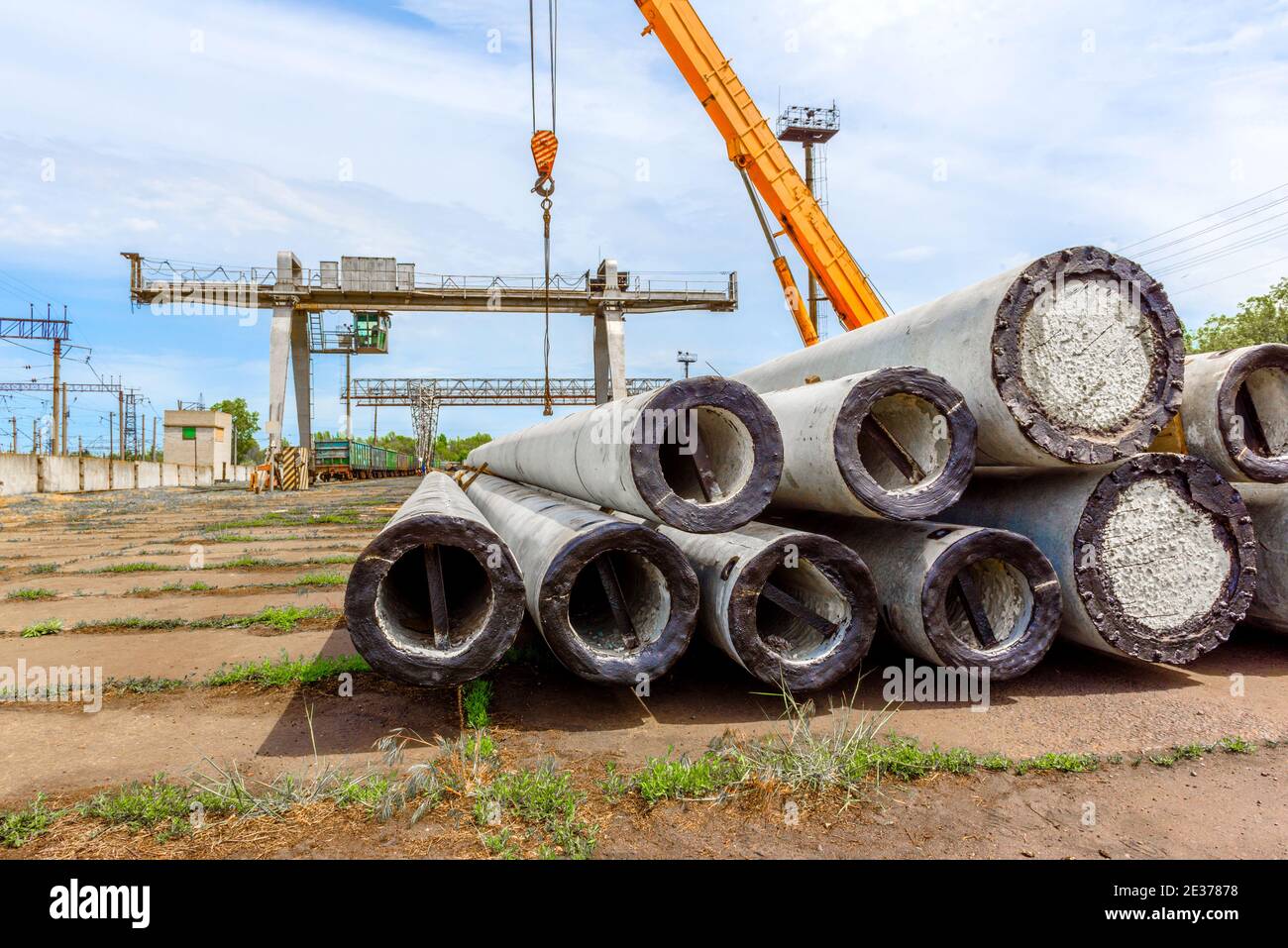Unloading of concrete high-voltage poles at the construction site using ...