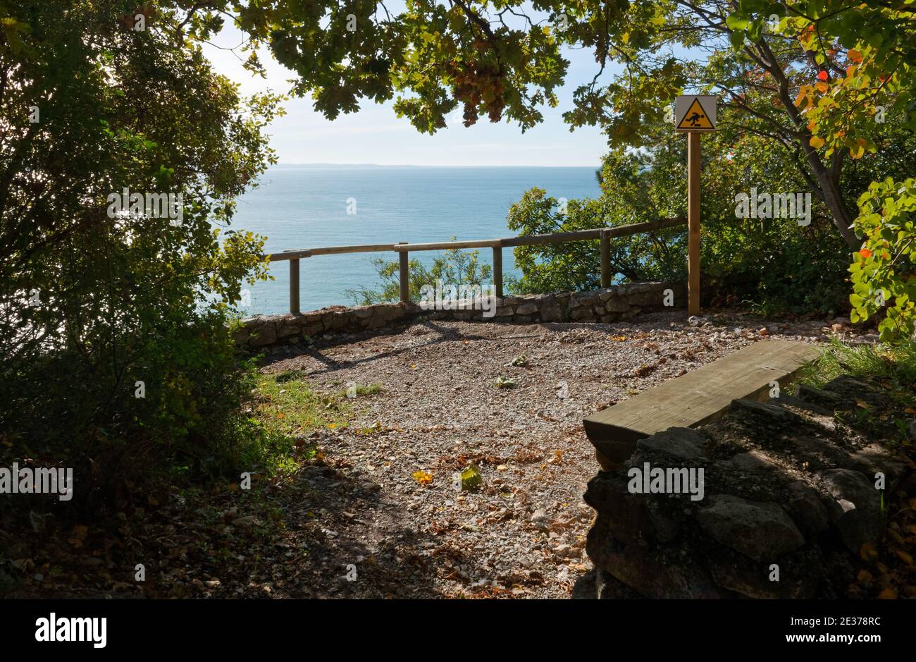 Shady overlook with a wooden seat along Rilke panoramic nature trail near Trieste, Italy Stock Photo