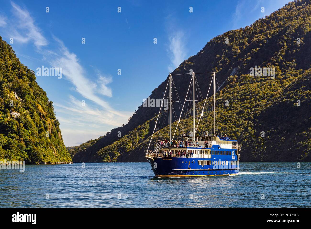 Milford Sound, or Piopiotahi, part of the fiords of the Southwest coastline on the South Island of New Zealand. The Milford Mariner with tourists. Stock Photo