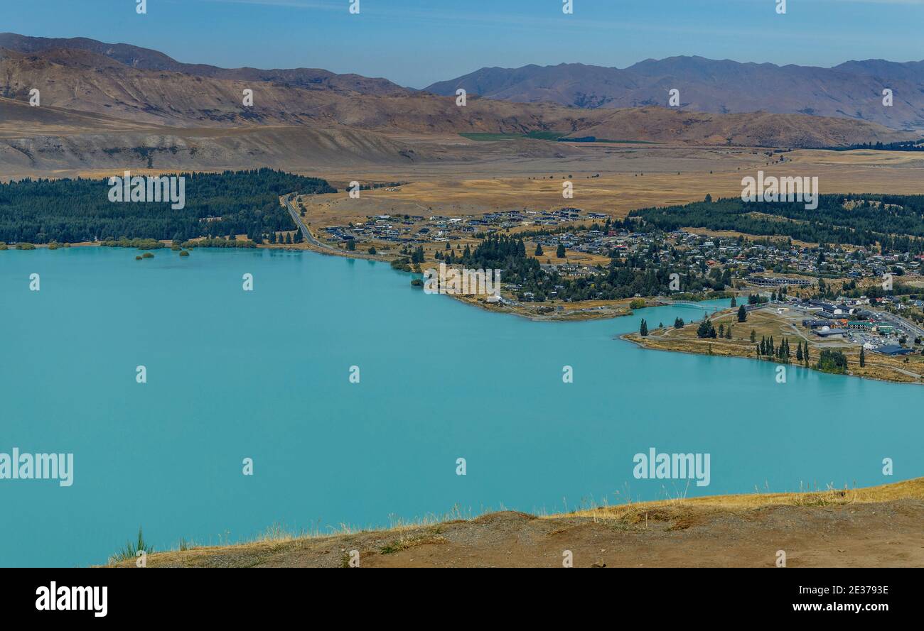 Pictured from Mount John is Lake Tekapo with the town at the waters edge, South Island, New Zealand. Stock Photo
