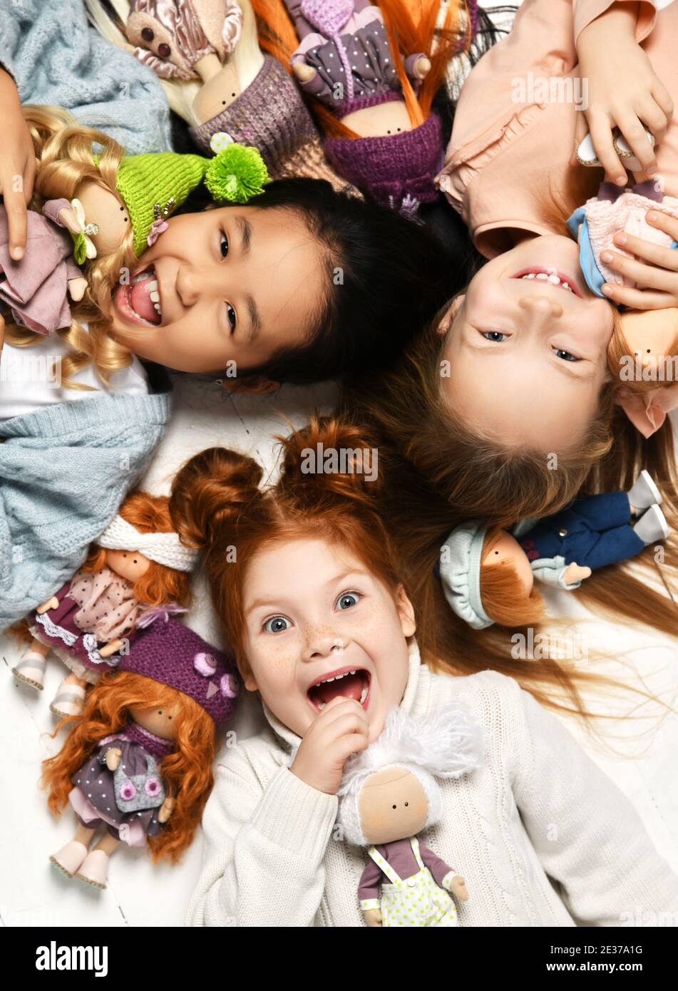 Children kids playing in kindergarten girls lying on a floor with