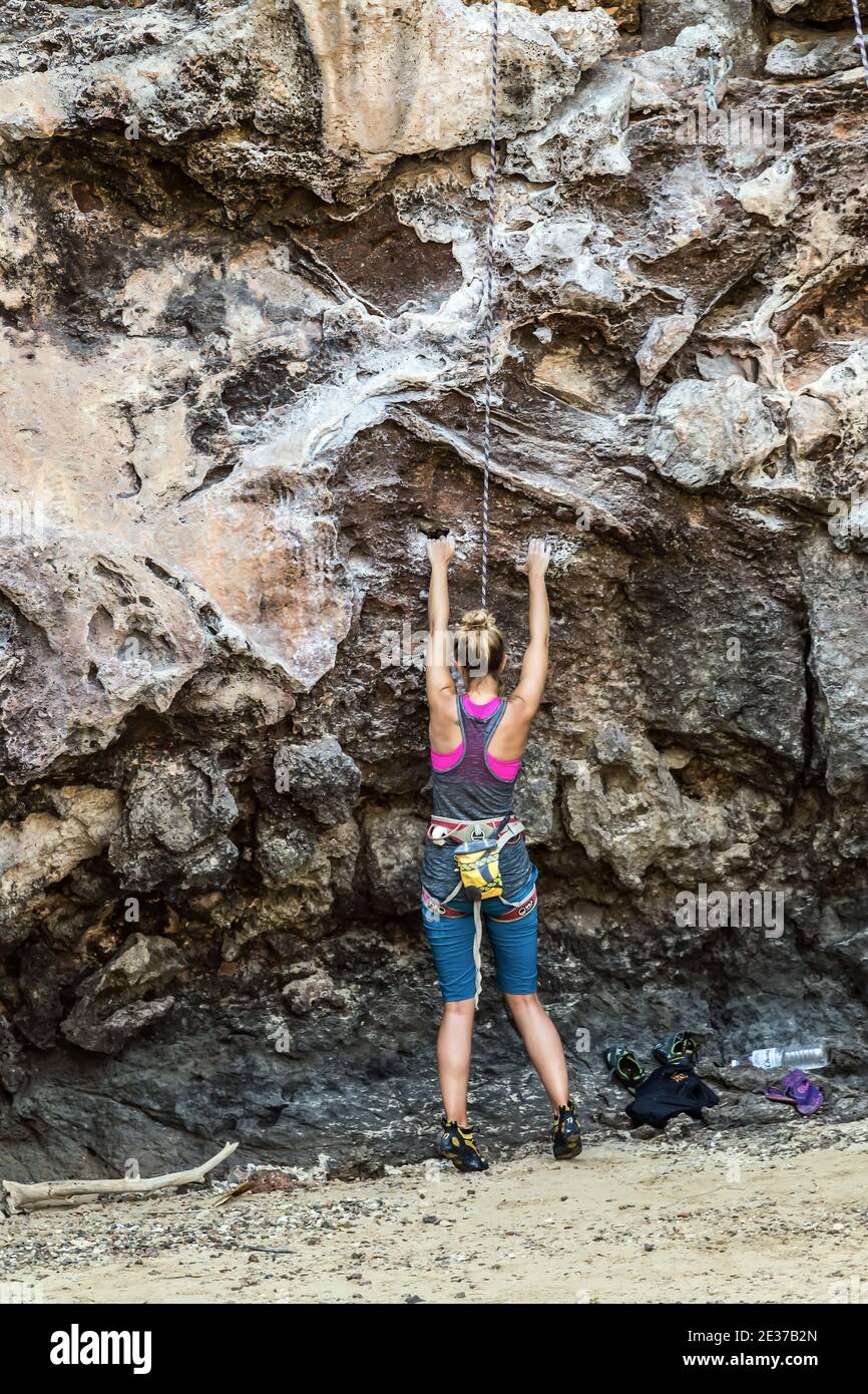 Top rope climbing rocks or top roping, anchor system at the top of the climb and down to a belayer at the foot of the climb. Stock Photo