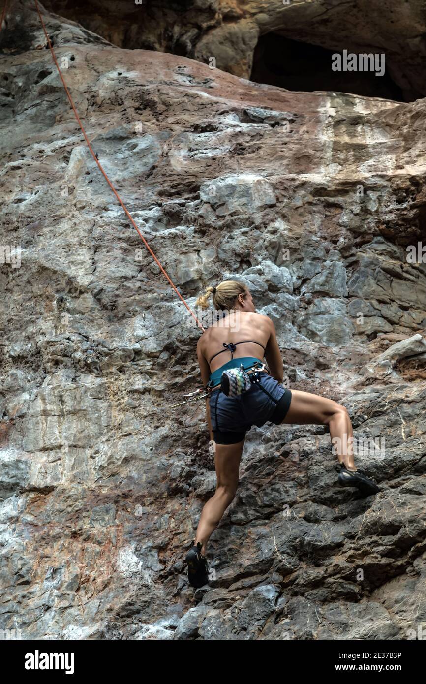 Top rope climbing rocks or top roping, anchor system at the top of the climb and down to a belayer at the foot of the climb. Stock Photo