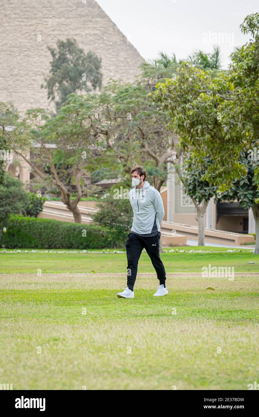 Kairo, Egypt. 17th Jan, 2021. Uwe Gensheimer (Rhein-Neckar Löwen) strolls  through the gardens of the hotel. In the background the pyramids of Giza.  The German national team is staying at the hotel "