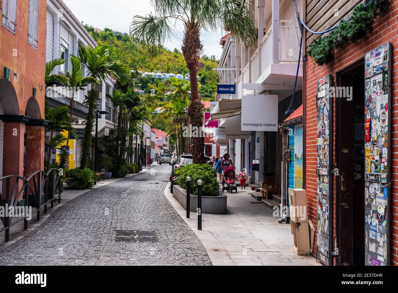 Gustavia, St Barths-- April 25, 2018. A pretty cobblestone street with retail stores on either side winds its way through  Gustavia, St. Barths. Edito Stock Photo