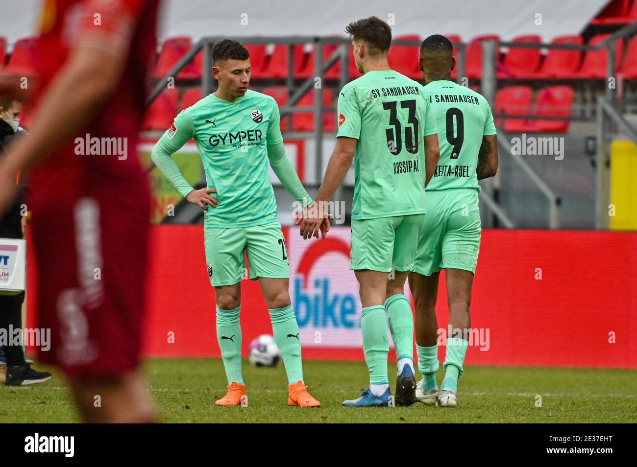 17 January 2021, Bavaria, Regensburg: Football: 2. Bundesliga, Jahn Regensburg - SV Sandhausen, Matchday 16. Enrique Peña Zauner of Sandhausen (l-r), Alexander Rossipal of Sandhausen and Daniel Keita-Ruel of Sandhausen stand disappointed on the pitch after the match against Regensburg lost 3:1. Photo: Armin Weigel/dpa - IMPORTANT NOTE: In accordance with the regulations of the DFL Deutsche Fußball Liga and/or the DFB Deutscher Fußball-Bund, it is prohibited to use or have used photographs taken in the stadium and/or of the match in the form of sequence pictures and/or video-like photo series. Stock Photo
