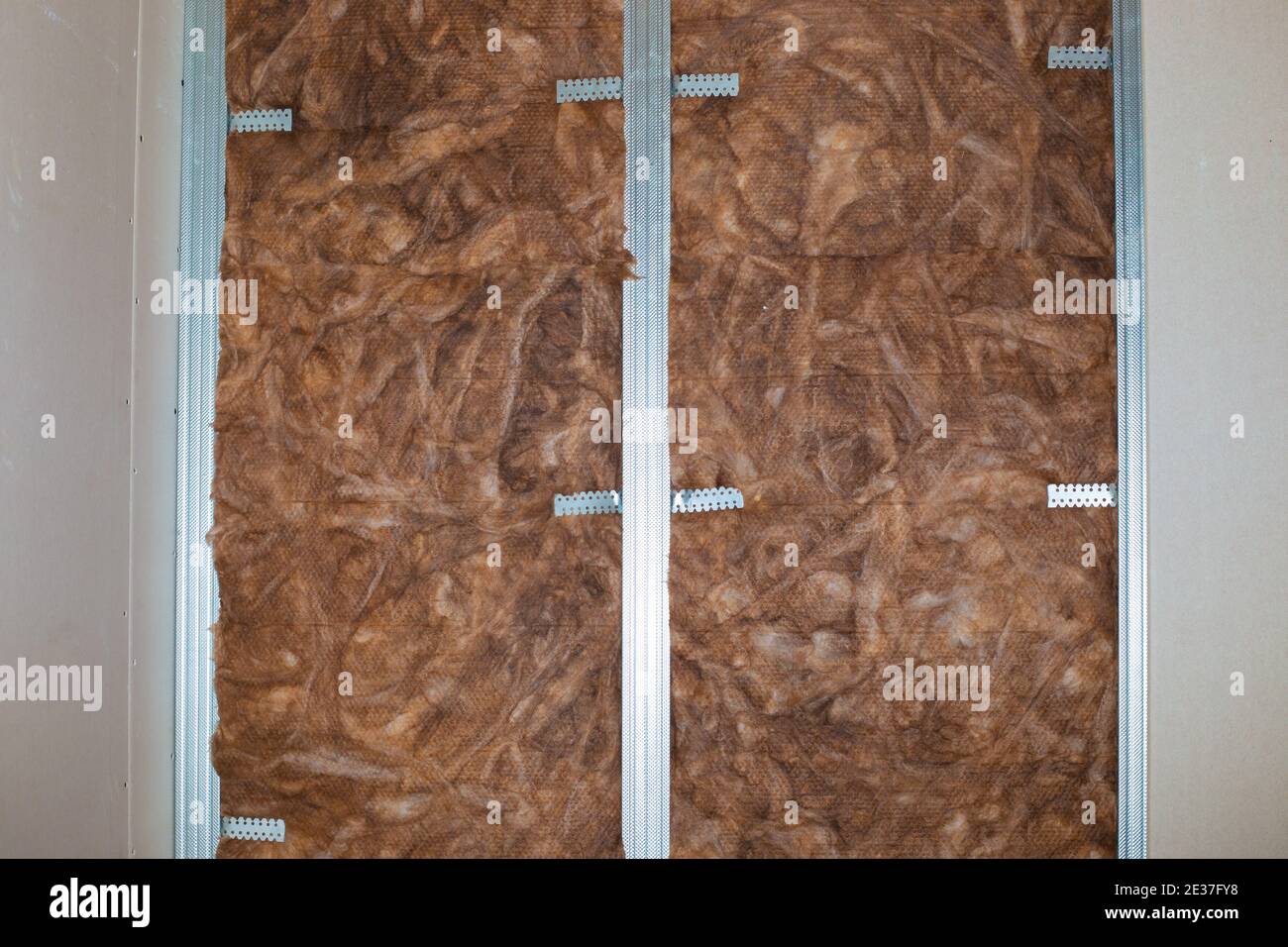 Insulation and sound insulation of walls with mineral wool, before facing with plasterboard. Home renovation,. Stock Photo