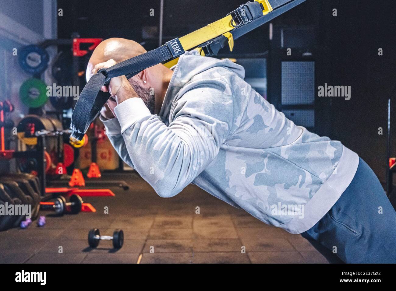 Man Does Crossfit exercise With Trx Fitness Straps In Gym Stock Photo ...