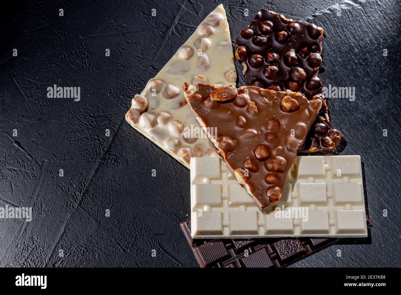 Chocolate Examples Three types of chocolate - black, milk and white on a black background ...