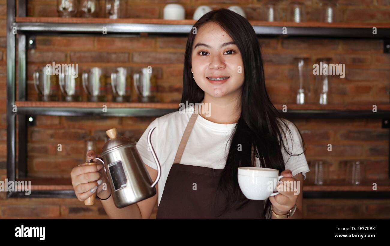 Asian Women pour coffee into a glass Stock Photo Alamy