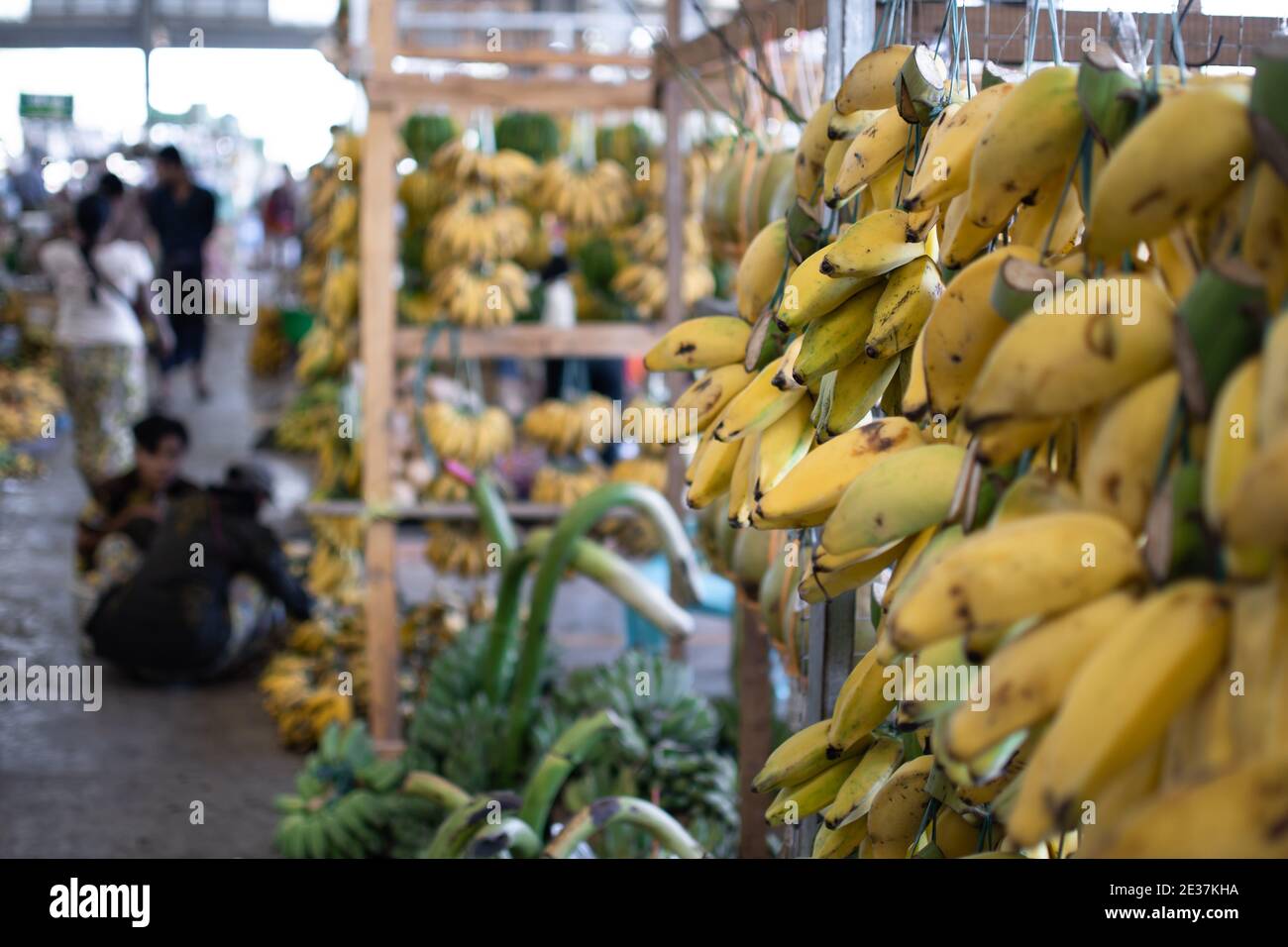 Small ripe yellow bananas being sold at a local traditional fruit and vegetables market in rural Myanmar near Yangon Stock Photo