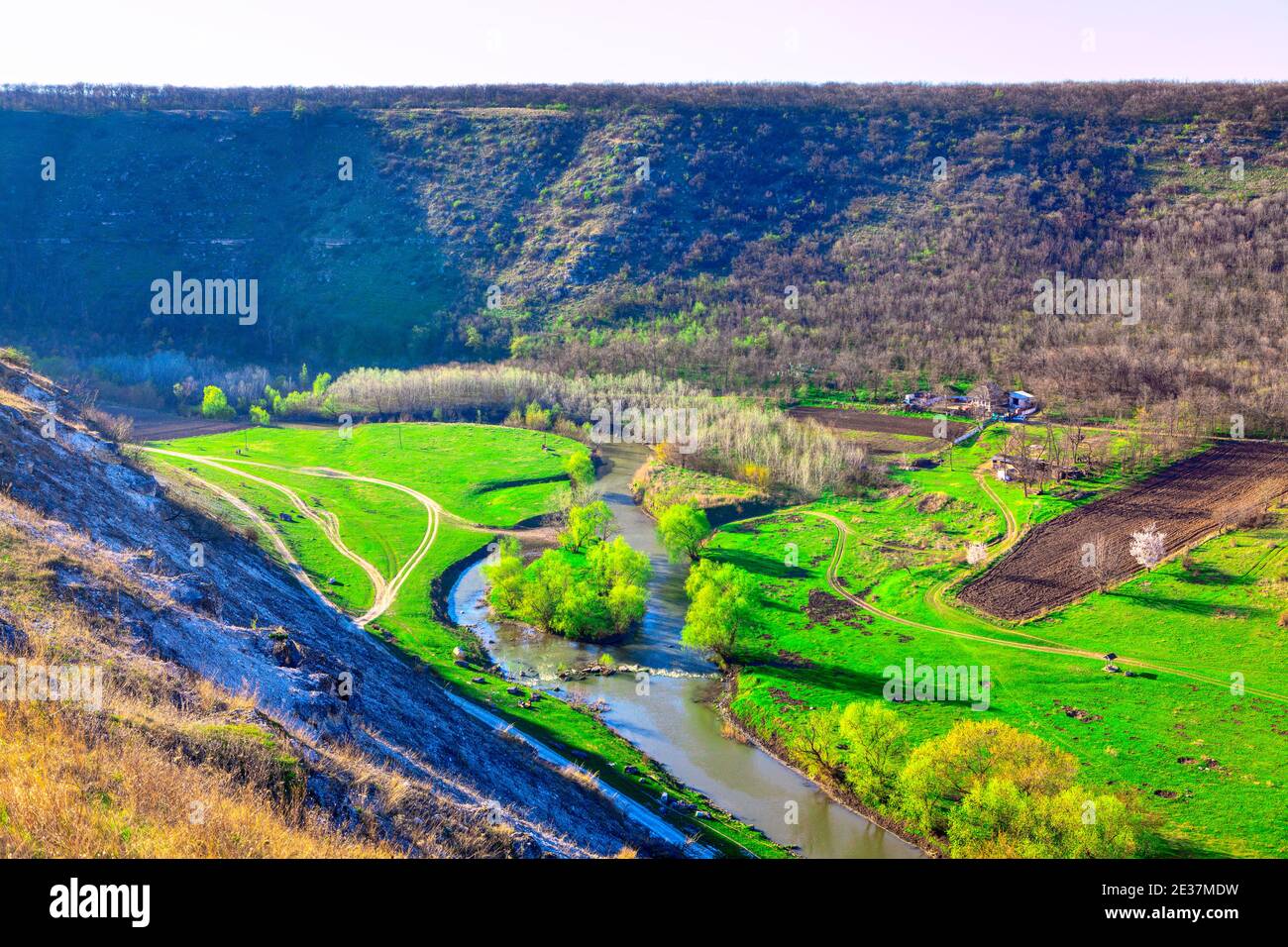 Green riverside valley . Spectacular spring landscape . Flowing river