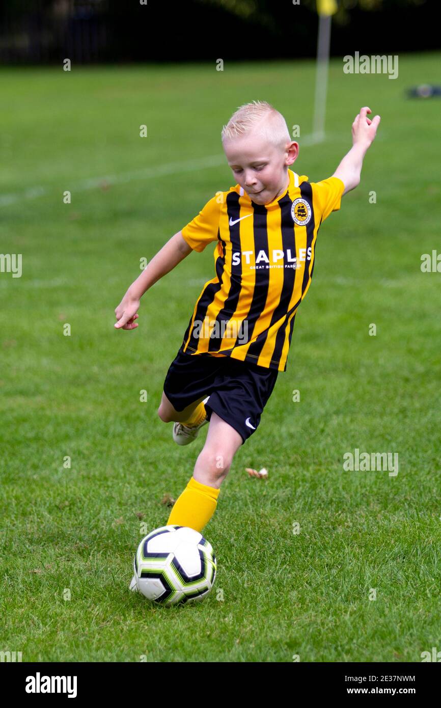 Grassroots football player taking a free kick in his soccer game Stock Photo