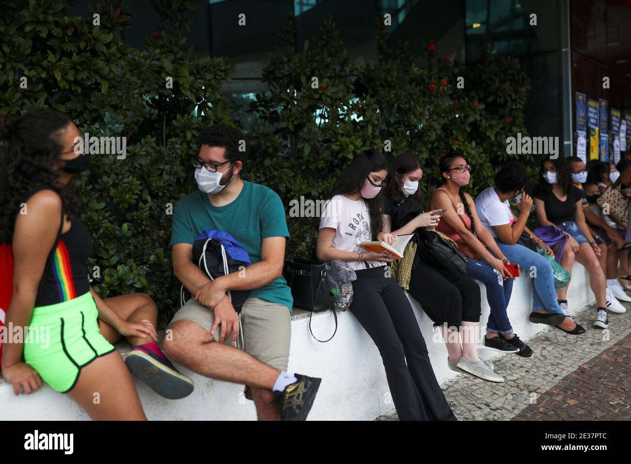 A student reads a book as people gather before the beginning of the ENEM, Exame Nacional do Ensino Medio (National High School Exam), during the outbreak of the coronavirus disease (COVID-19), at UNIP Vergueiro test site in Sao Paulo, Brazil January 17, 2021. REUTERS/Amanda Perobelli Stock Photo