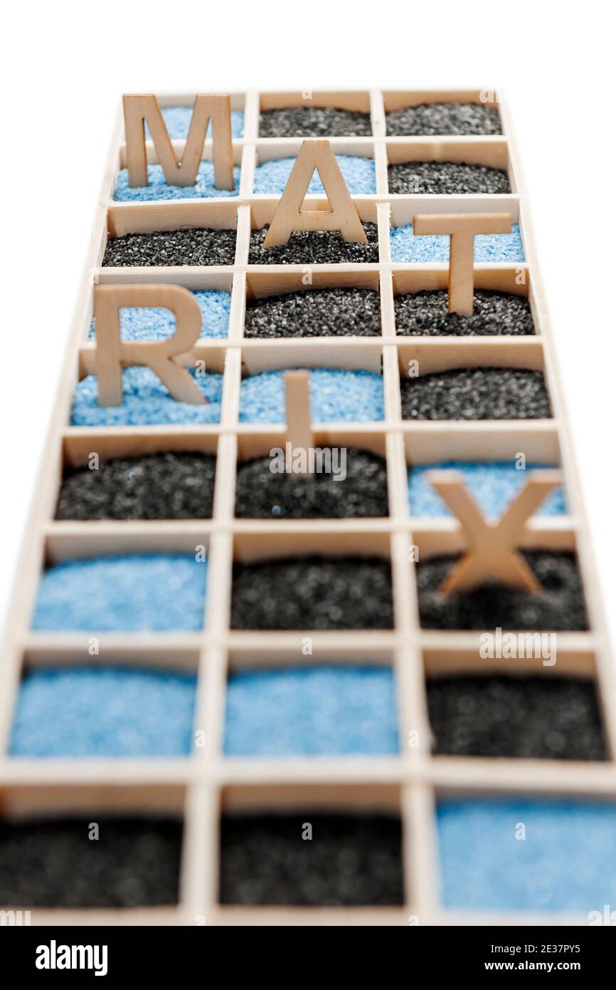 Low angle view of a wooden box with square compartments rectangular compartments filled with blue or black decorative sand. Stock Photo