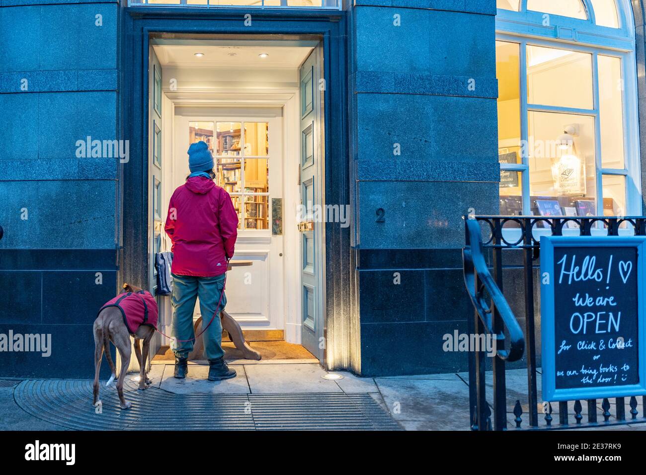 Edinburgh, Scotland, UK. 17 January 2021. On first Sunday after tightening of national lockdown rules in Scotland a customer waits outside Topping & Co bookshop to use click & collect service. Iain Masterton/Alamy Live News Stock Photo