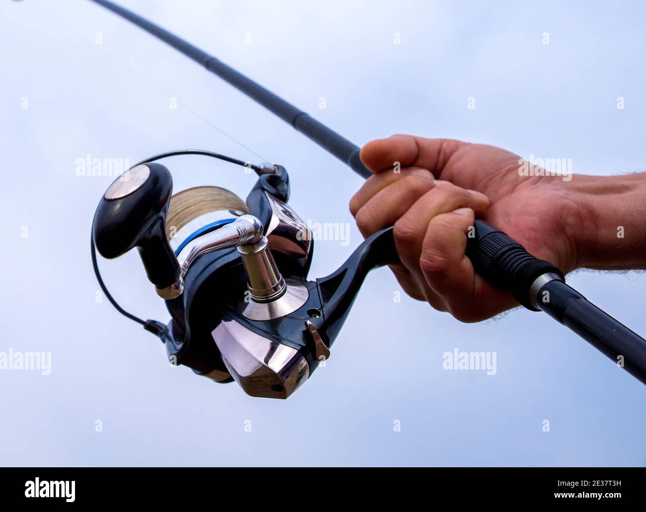Man hand holding fishing rod Stock Photo Alamy