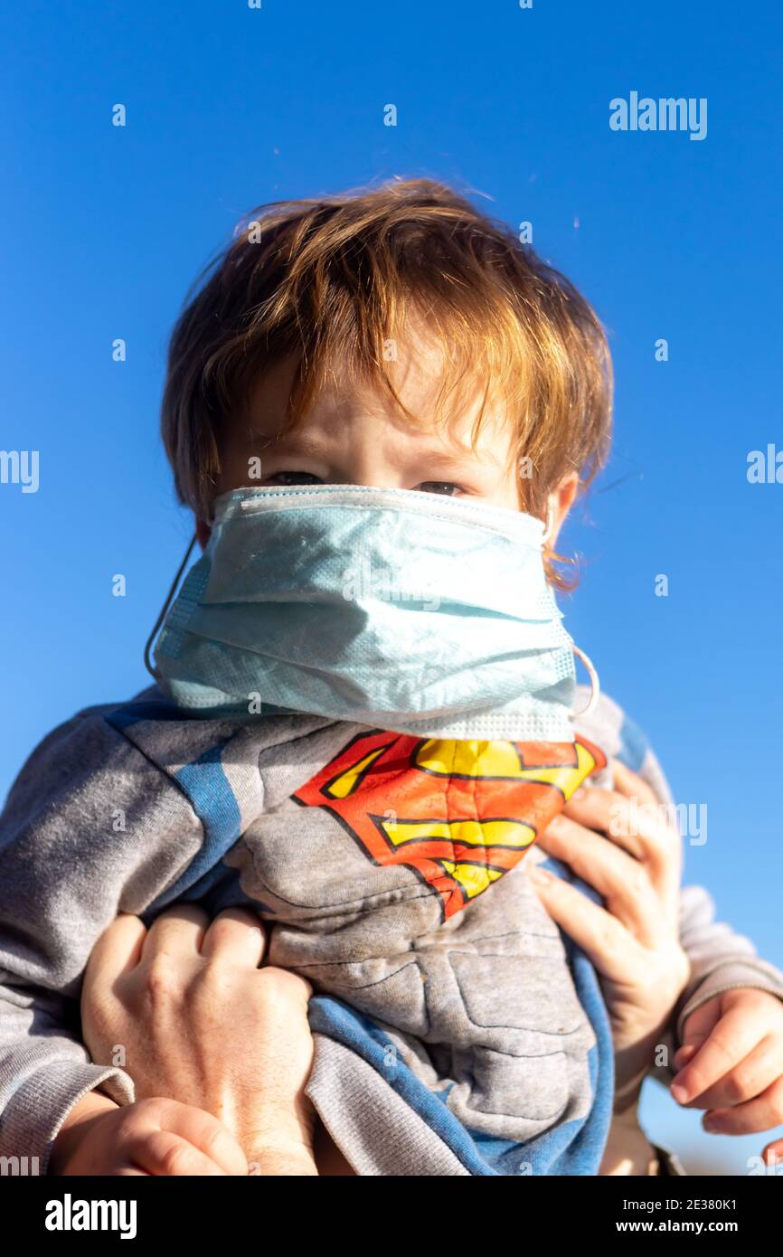 A little child with a surgical face mask Stock Photo