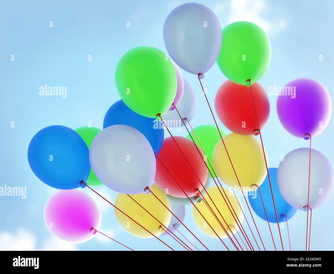 Colorful balloons rising up in the air Stock Photo