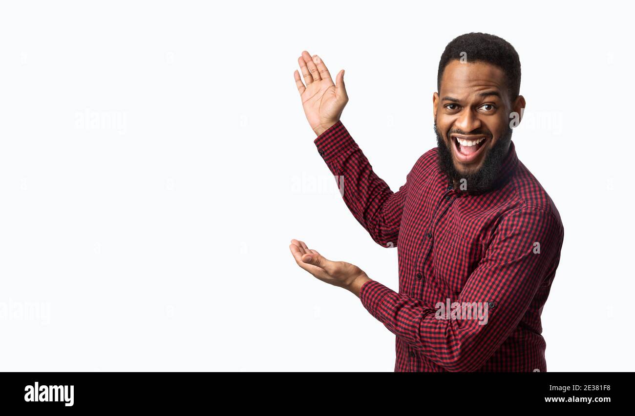 Excited African Man Showing Blank Space Aside Over White Background ...