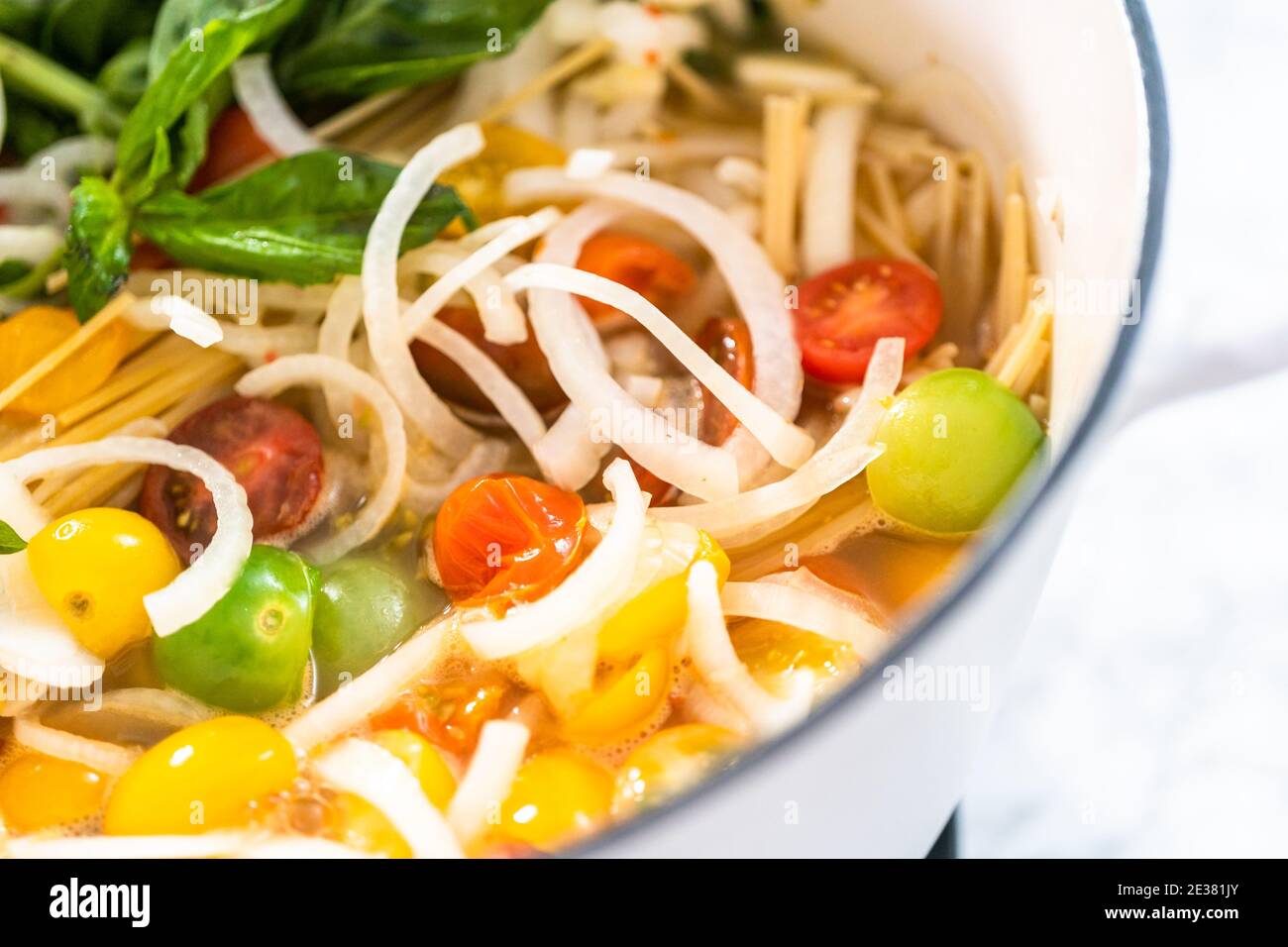 Preparing one pot pasta in enameled cast iron dutch oven Stock Photo Alamy