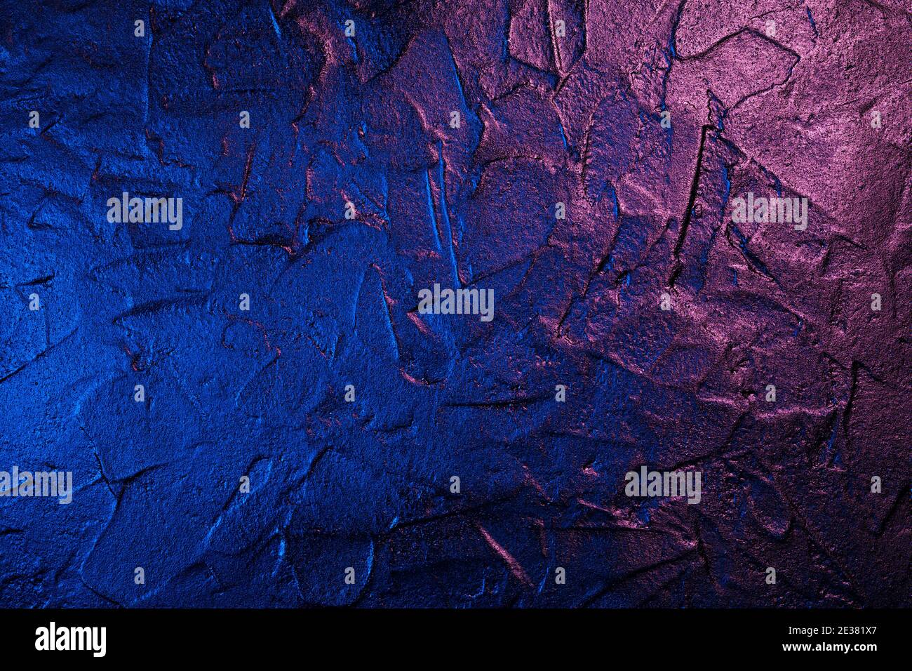 Art plastered black wall texture background in neon light Stock Photo