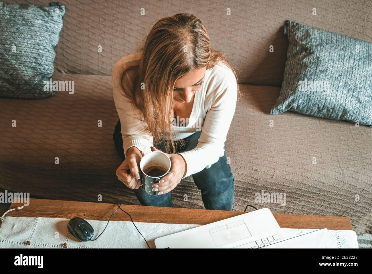 A woman drinking coffee at home Stock Photo