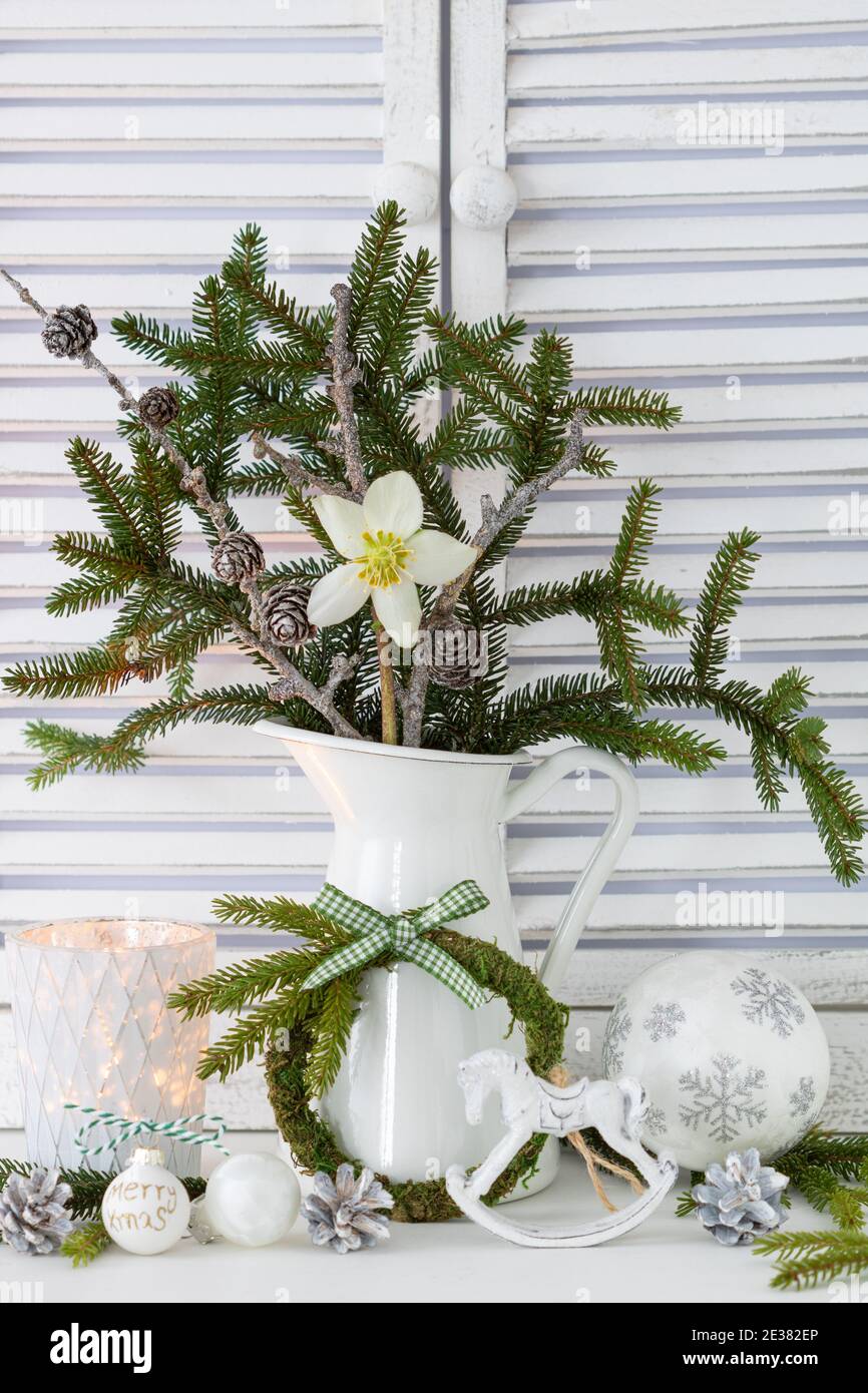 bouquet with helleborus niger flower, fir branches and larch cones as christmas decoration Stock Photo