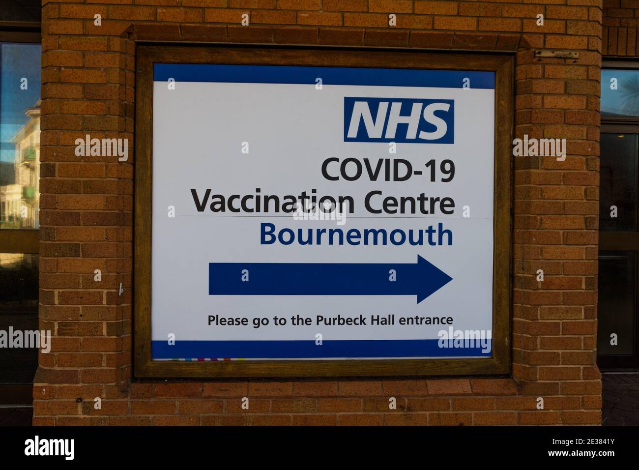 Bournemouth, England – Sign to entrance of NHS COVID-19 Vaccination Centre at Bournemouth International Centre, on January  17 2021 in UK. Stock Photo