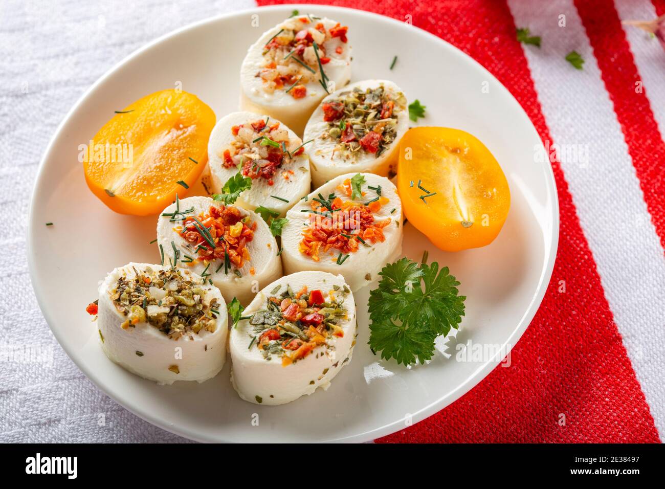 Small cheese appetizers with herbs and dried vegetables Stock Photo