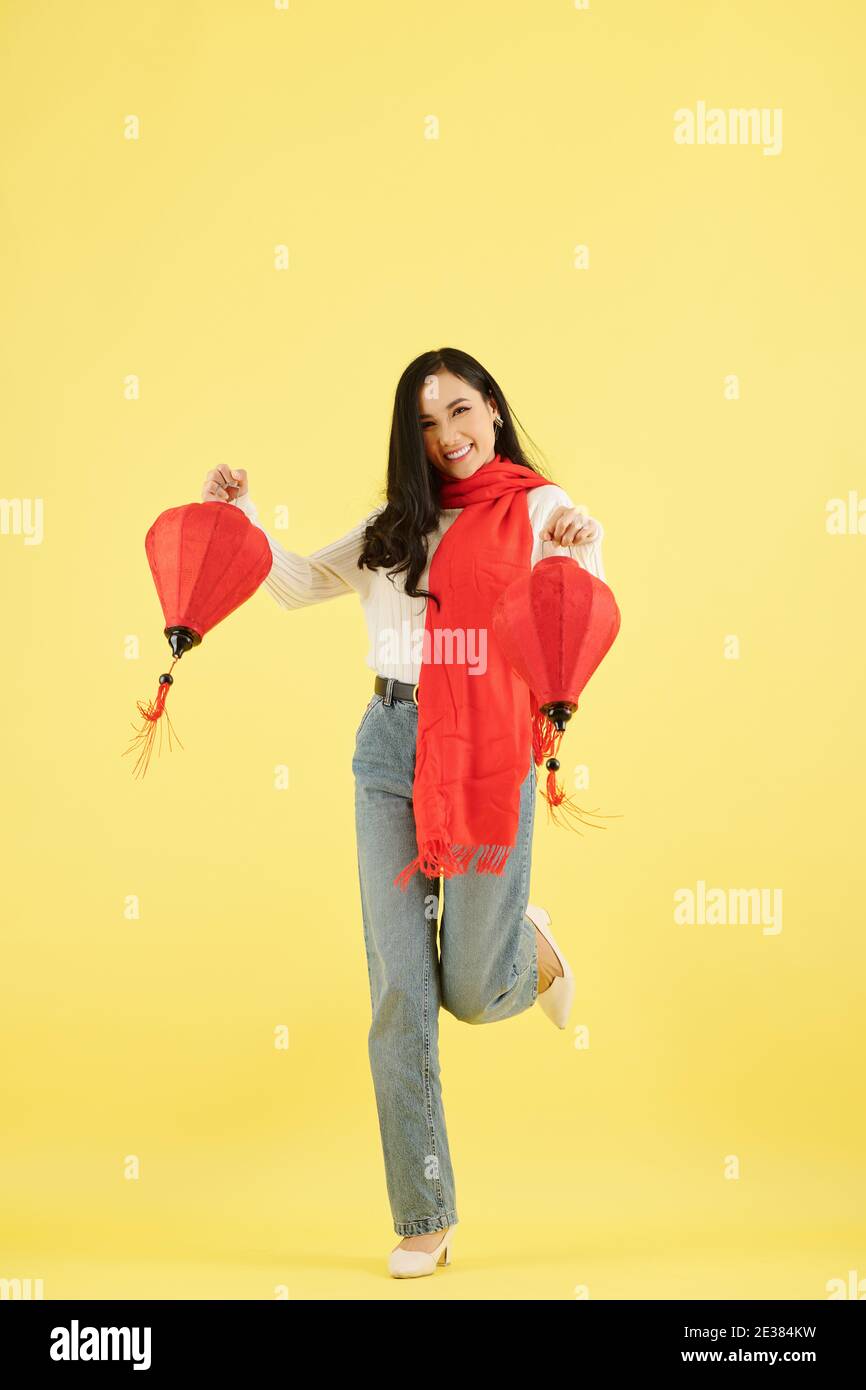 Beautiful young Asian woman dancing with paper lanterns for Chinese New Year celebration Stock Photo