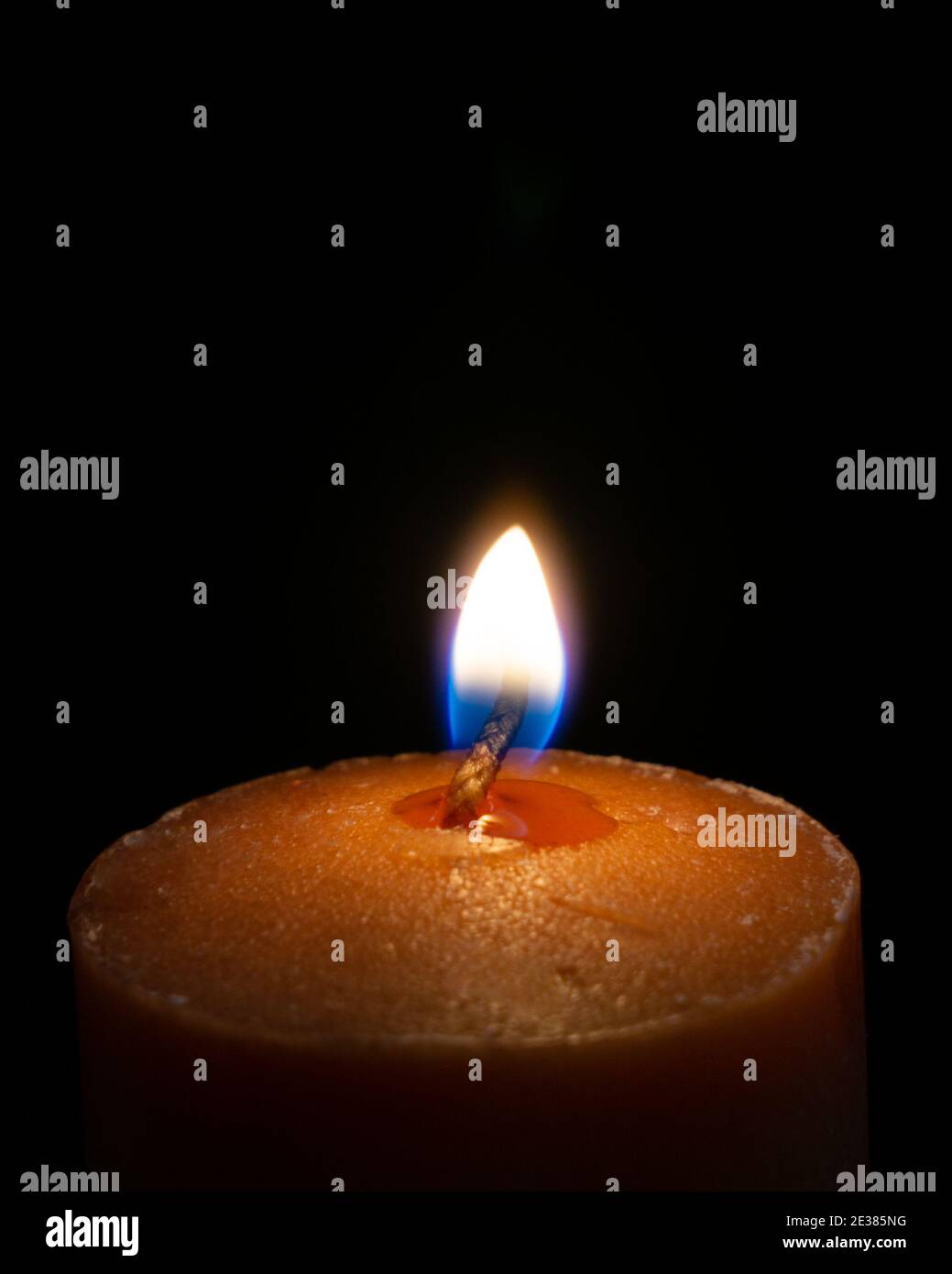 A closeup of a burning candle in the dark Stock Photo Alamy