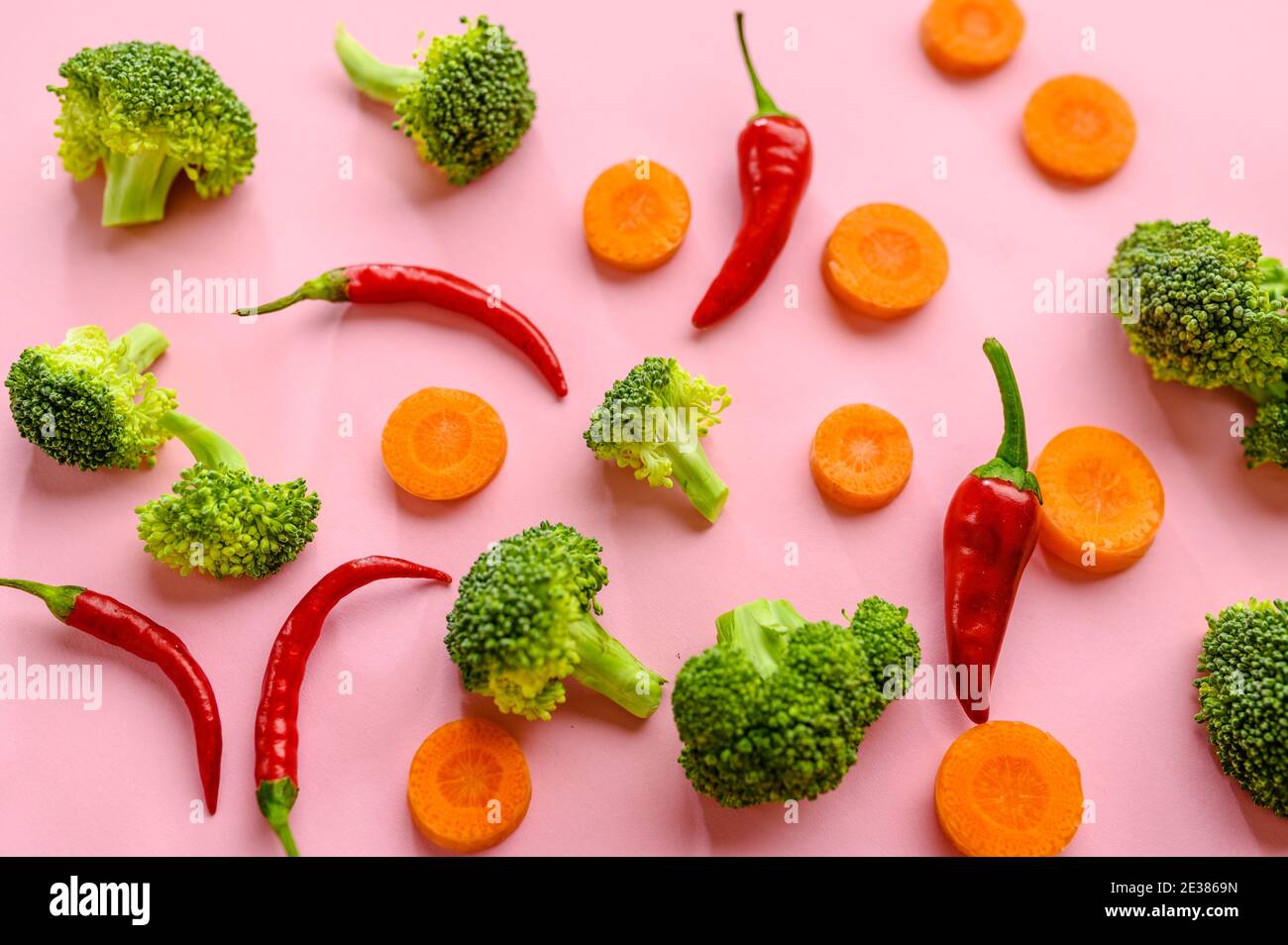 Broccoli, pepper and carrot on pink background Stock Photo Alamy