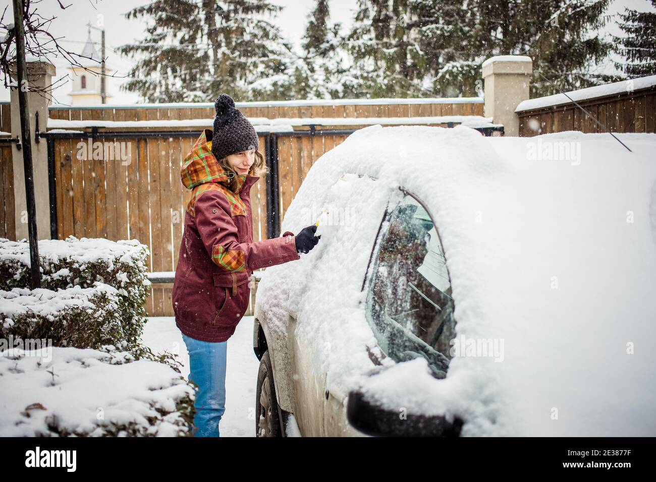 woman cleaning snow from car after blizzard Stock Photo - Alamy