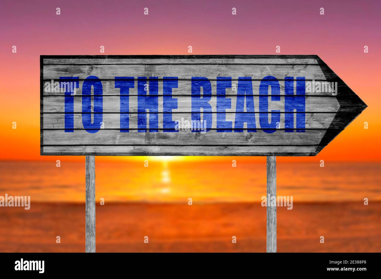 To The Beach wooden sign with on a beach background Stock Photo - Alamy