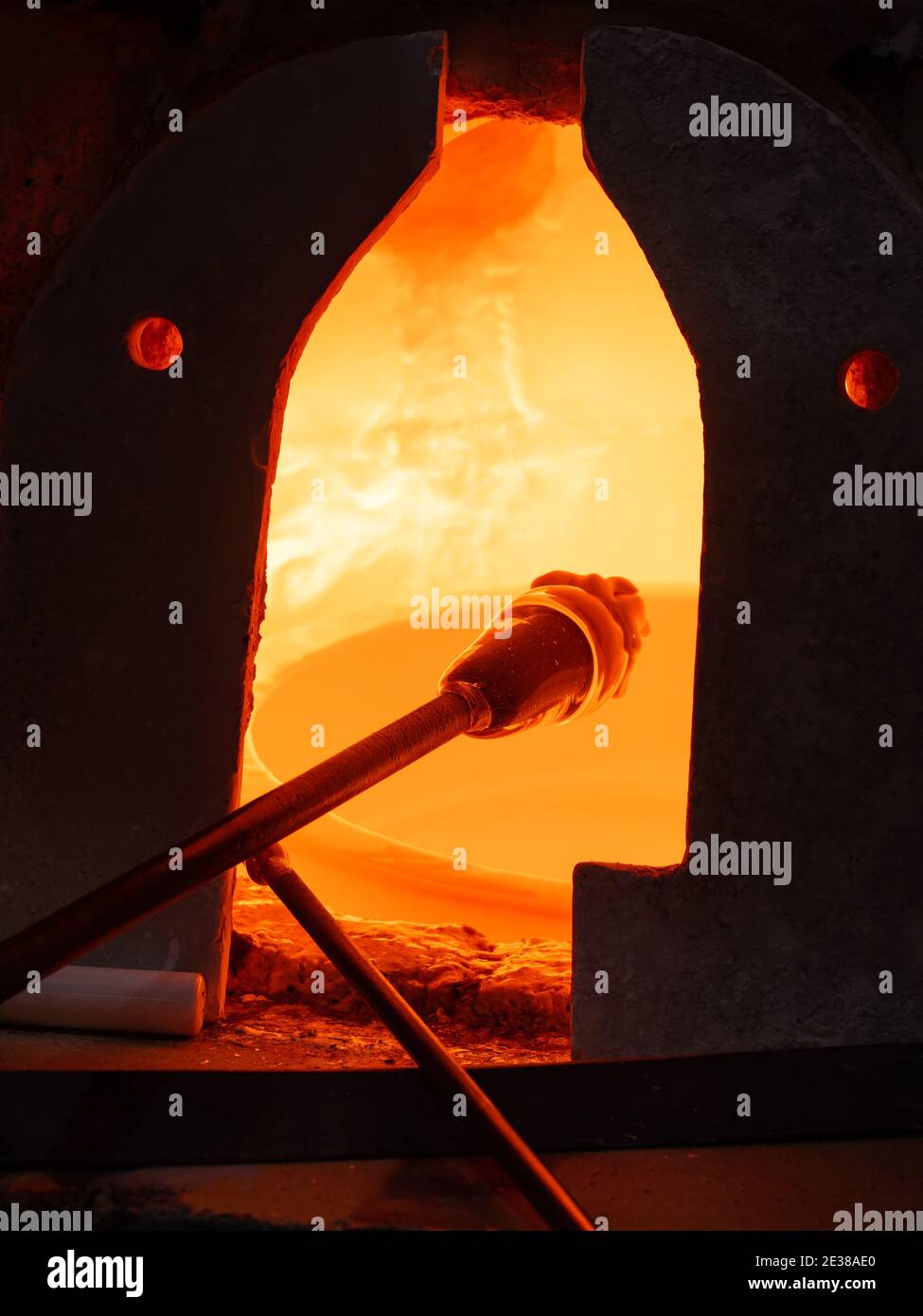 Traditional glass blowing process inhandmade glass studio. Glassblower