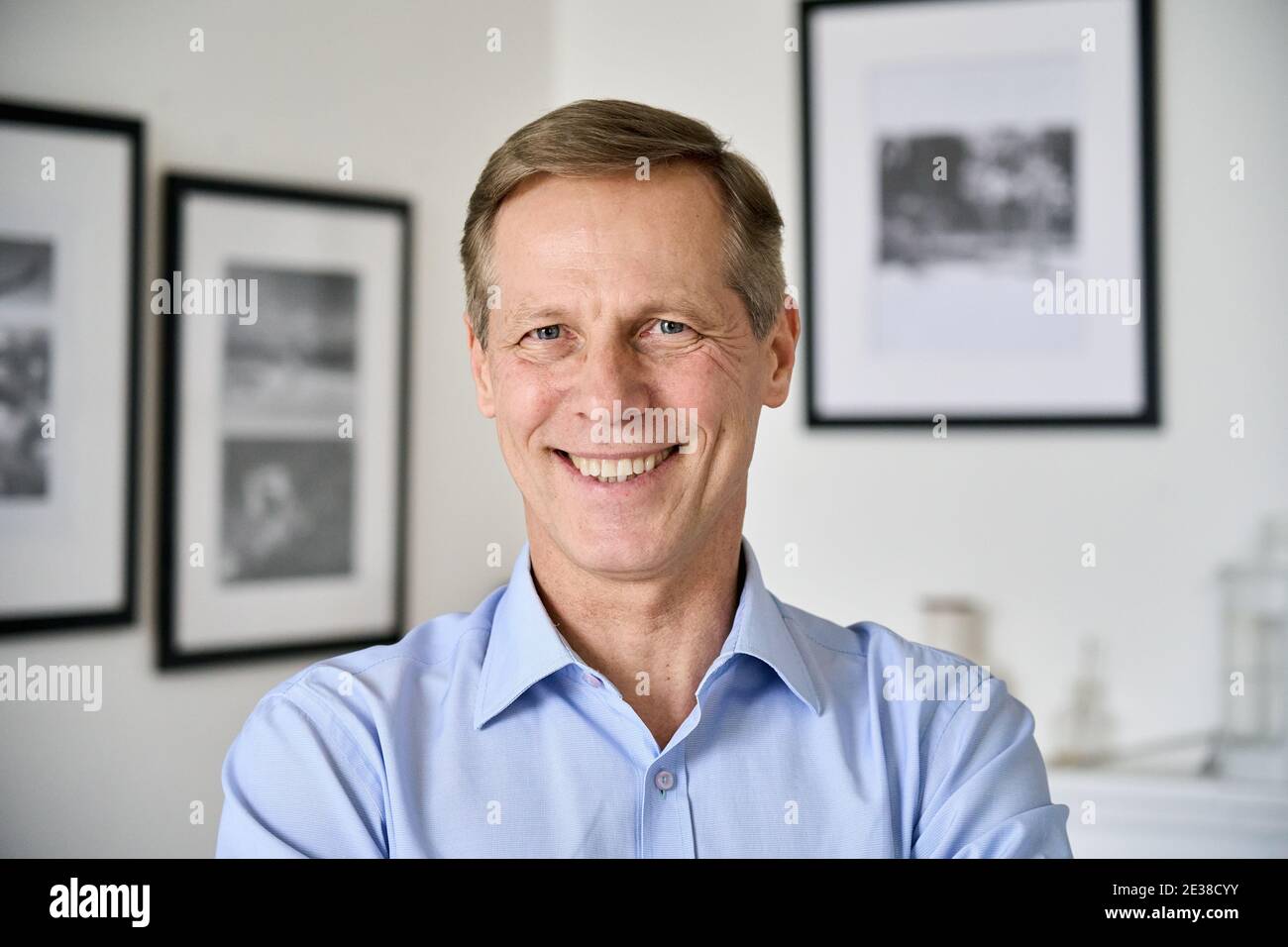 Smiling middle aged 50s man looking at camera at home, headshot portrait. Stock Photo