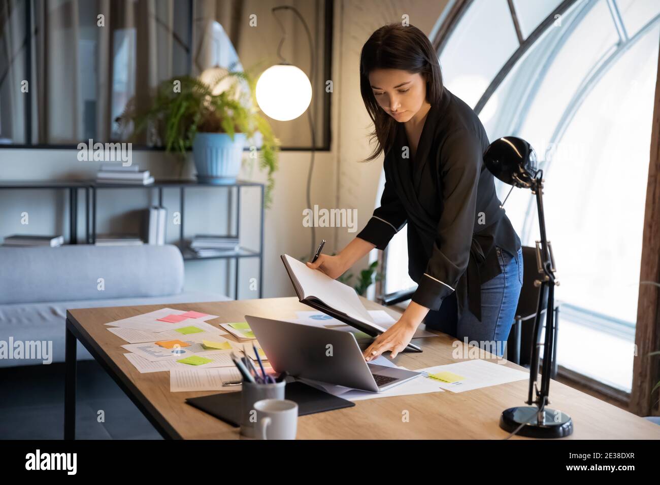 Confident Indian businesswoman working with project statistics in office Stock Photo
