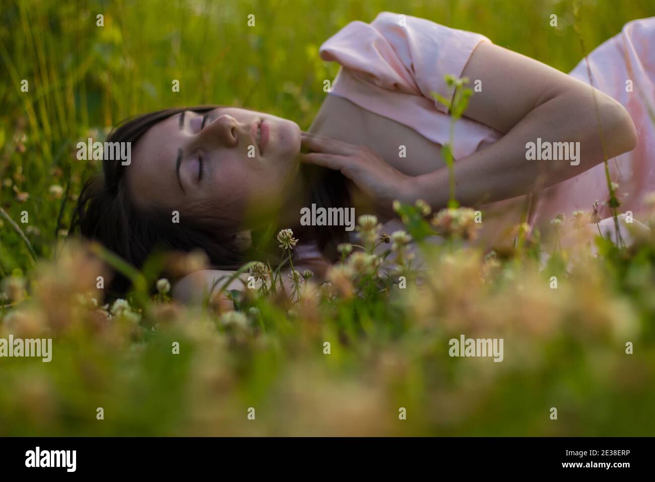 Photo of beautiful sleeping woman in the fild with wildflowers Stock Photo