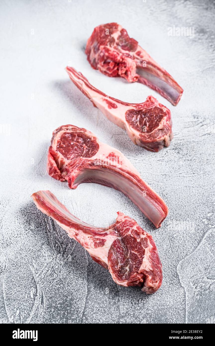 https://c8.alamy.com/comp/2E38EY2/raw-lamb-meat-chops-on-a-butcher-table-white-background-top-view-2E38EY2.jpg