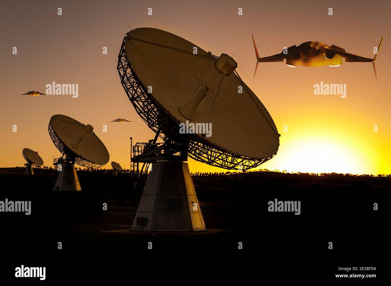 Three futuristic alien space craft approach an array of large telecommunication and satellite tracking dishes that face the sky at sunset. Stock Photo