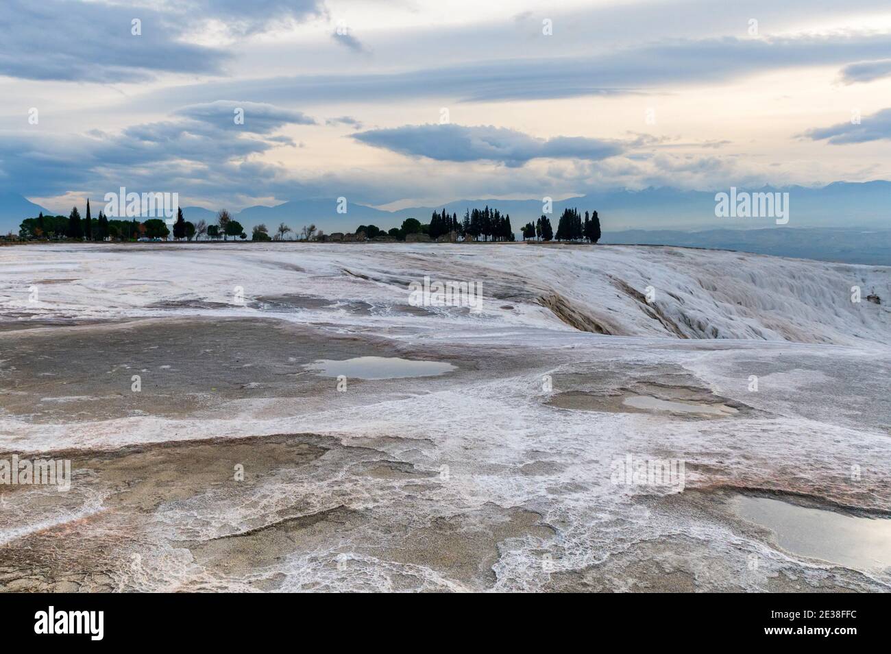 Travertine pools or terraces Pamukkale, Turkey. White rocks included in ...
