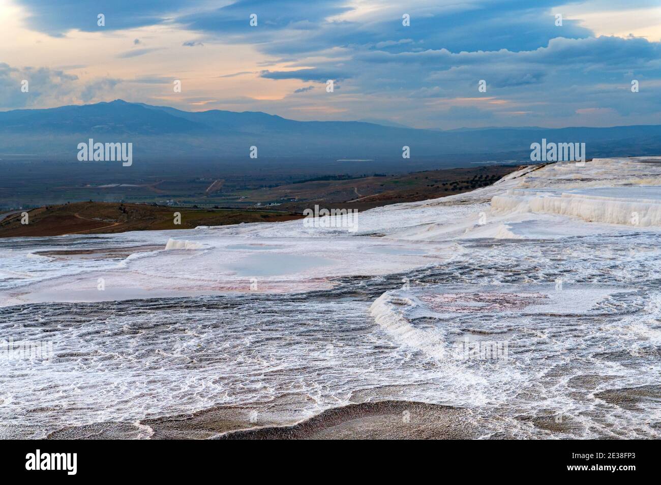 Travertine pools or terraces Pamukkale, Turkey. White rocks included in ...