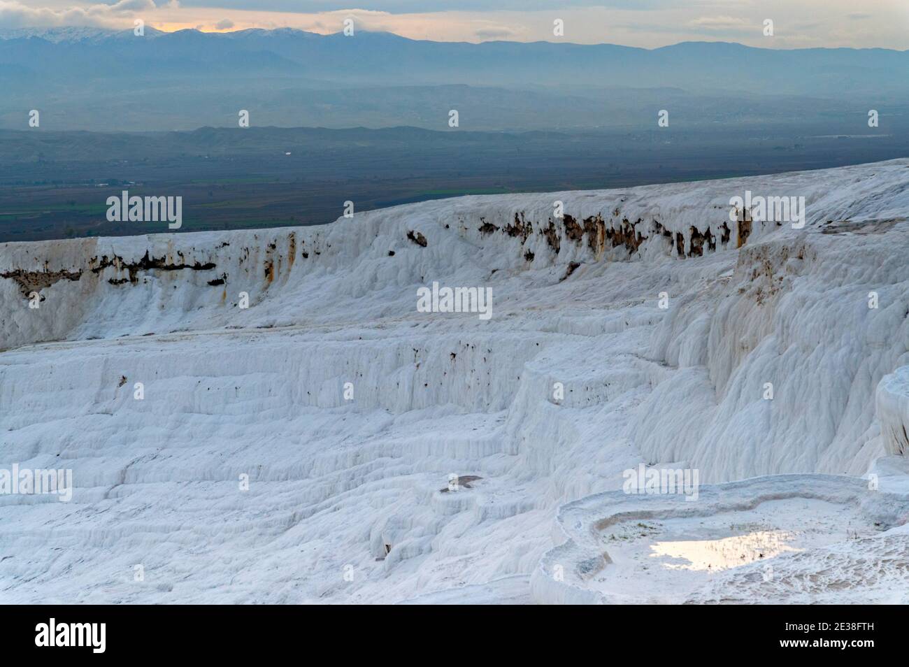 Travertine pools or terraces Pamukkale, Turkey. White rocks included in ...