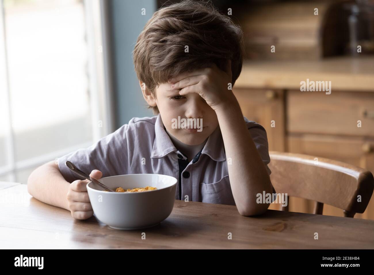Unhappy small boy refuse eating healthy breakfast Stock Photo