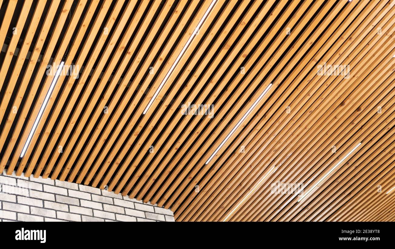 rechtbank verantwoordelijkheid Narabar Loft style wooden plank ceiling design idea. Slatted wooden ceiling in the  interior. Designer ceiling close-up. LED strip lamps in the design of a woo  Stock Photo - Alamy