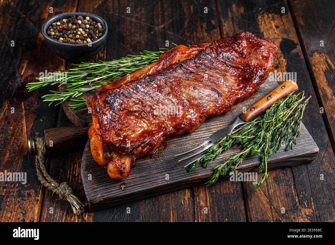 BBQ grilled veal calf brisket meat on short spare rib on wooden cutting  board. Dark wooden background. Top view Stock Photo - Alamy