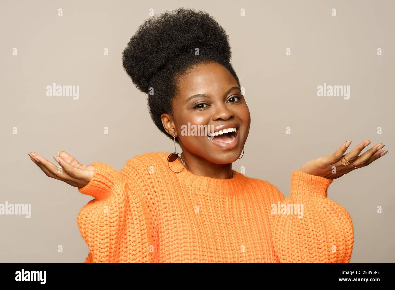 Emotional surprised Afro woman throw hands up as sign of astonishment